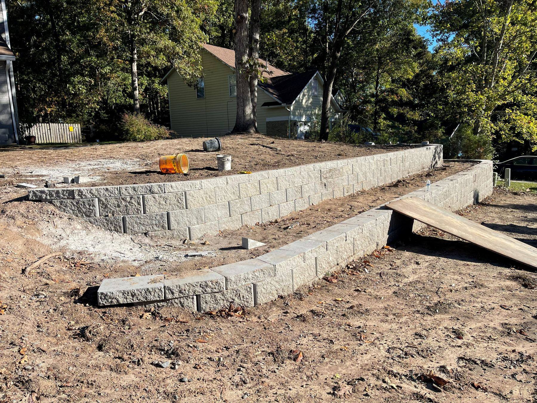 Retaining wall under construction showing base and block courses